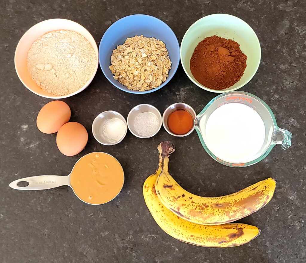 Ingredients needed to bake a healthy chocolate banana muffin.