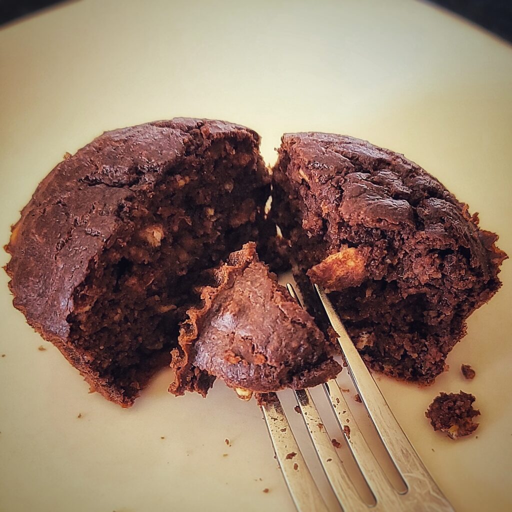 A healthy chocolate banana oat muffin on a plate.